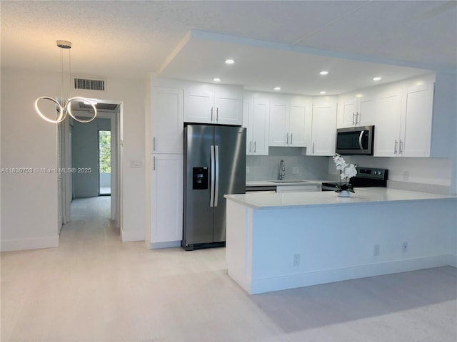 4025 Ellesmere B 4025, Deerfield Beach, FL 33442 - kitchen featuring stainless steel appliances, light countertops, white cabinetry, a peninsula, and recessed lighting