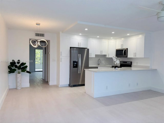 4025 Ellesmere B 4025, Deerfield Beach, FL 33442 - kitchen with stainless steel appliances, light countertops, white cabinetry, a peninsula, and recessed lighting