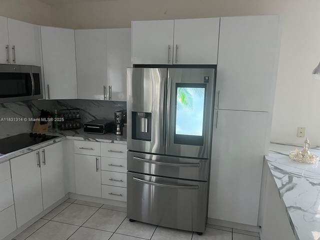 15271 NW 6th Ct, Pembroke Pines, FL 33028 - kitchen with stainless steel appliances, white cabinets, decorative backsplash, and light tile patterned floors