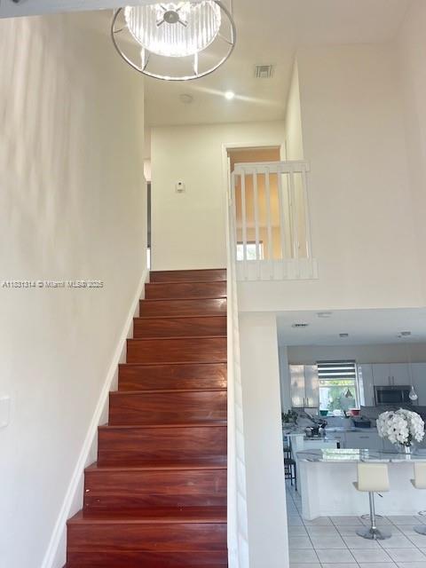 15271 NW 6th Ct, Pembroke Pines, FL 33028 - stairway with tile patterned flooring and a chandelier