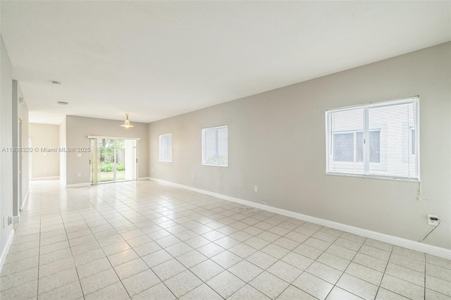 3156 NE 4th St, Homestead, FL 33033 - empty room featuring light tile patterned flooring and baseboards
