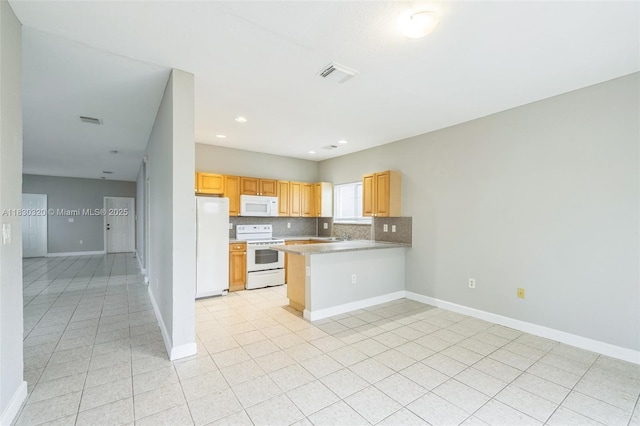 3156 NE 4th St, Homestead, FL 33033 - kitchen featuring white appliances, a peninsula, backsplash, light tile patterned flooring, and recessed lighting