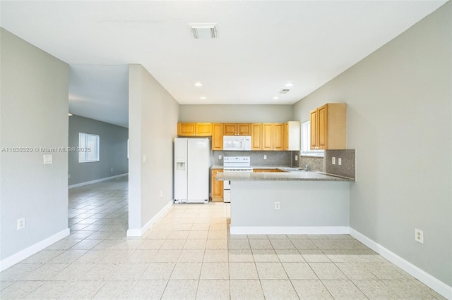 3156 NE 4th St, Homestead, FL 33033 - kitchen featuring white appliances, a peninsula, tasteful backsplash, light tile patterned flooring, and recessed lighting