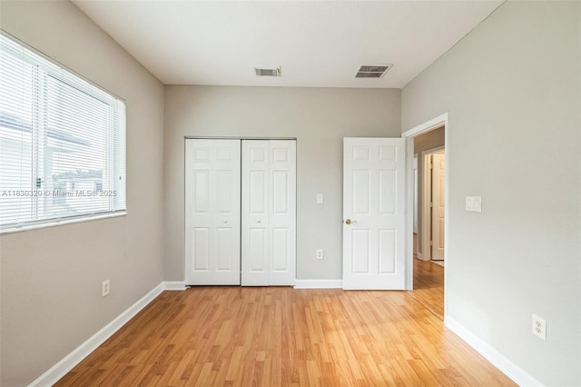3156 NE 4th St, Homestead, FL 33033 - unfurnished bedroom with light wood-style floors and a closet
