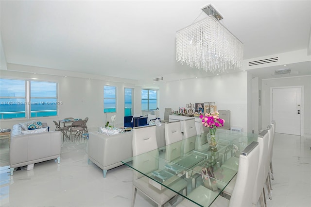 9511 Collins Ave Unit 1502, Surfside, FL 33154 - dining room featuring light marble finish floors and a chandelier