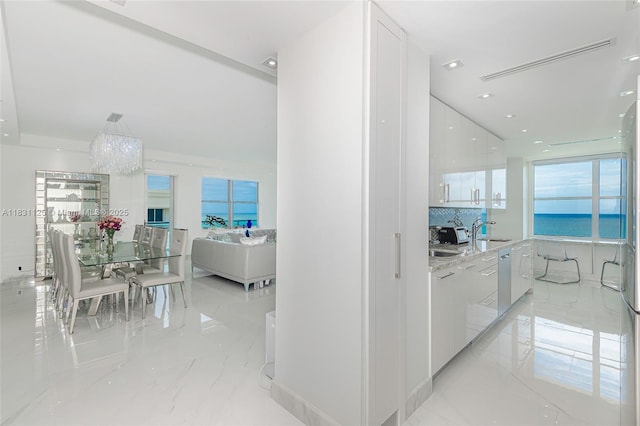 9511 Collins Ave Unit 1502, Surfside, FL 33154 - corridor featuring a chandelier and light marble finish flooring