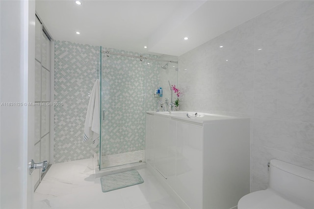 9511 Collins Ave Unit 1502, Surfside, FL 33154 - full bathroom featuring tile walls, a shower stall, a bath, and recessed lighting
