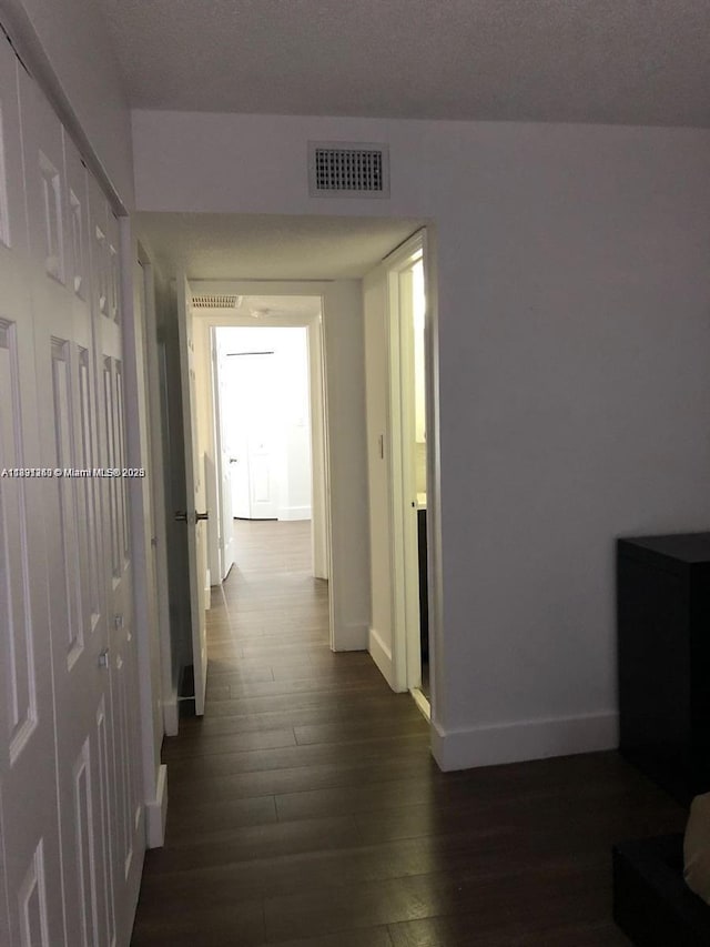 8670 NW 6th Ln Unit 4-208, Miami, FL 33126 - corridor with dark wood-type flooring and baseboards