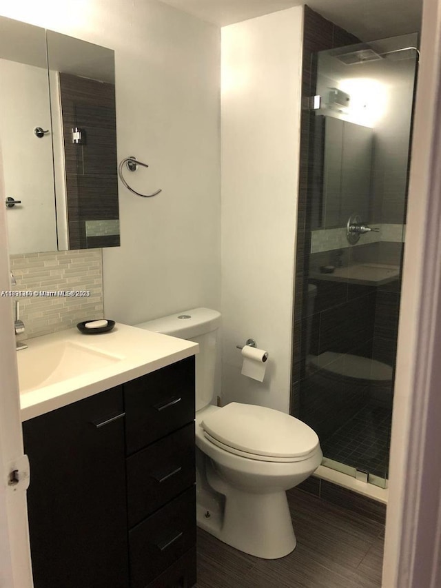 8670 NW 6th Ln Unit 4-208, Miami, FL 33126 - bathroom featuring vanity, a shower stall, tasteful backsplash, and wood finished floors