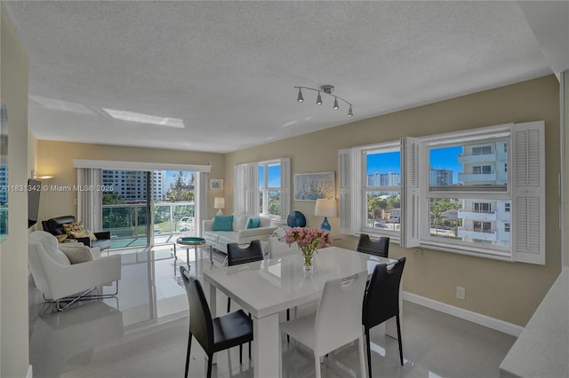 1620 N Ocean Blvd Unit 510, Pompano Beach, FL 33062 - dining room with a textured ceiling and baseboards