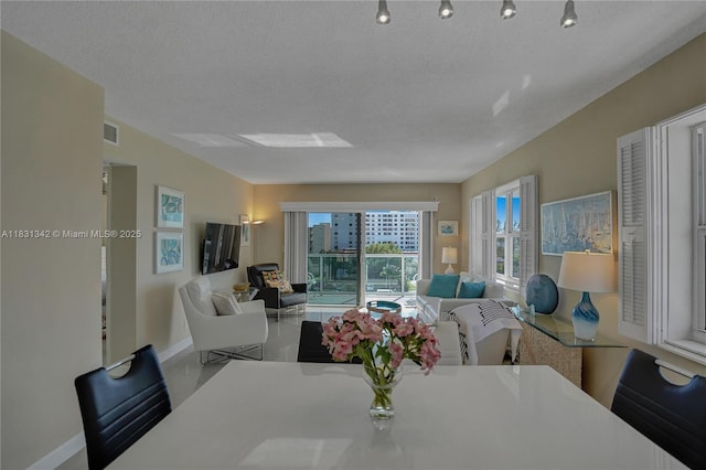 1620 N Ocean Blvd Unit 510, Pompano Beach, FL 33062 - dining space featuring baseboards and a textured ceiling