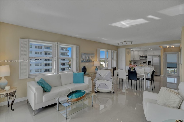 1620 N Ocean Blvd Unit 510, Pompano Beach, FL 33062 - living room featuring light tile patterned flooring and baseboards