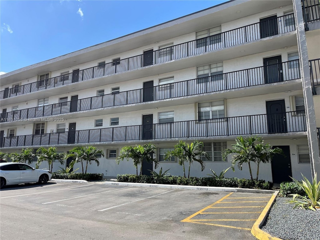 14155 SW 87th St Unit E103, Miami, FL 33183 - view of apartment building / complex featuring uncovered parking