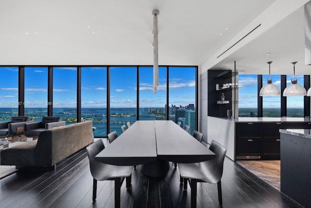788 NE 23rd St Unit 5401, Miami, FL 33137 - dining space featuring dark wood-type flooring, a water view, a wall of windows, and plenty of natural light