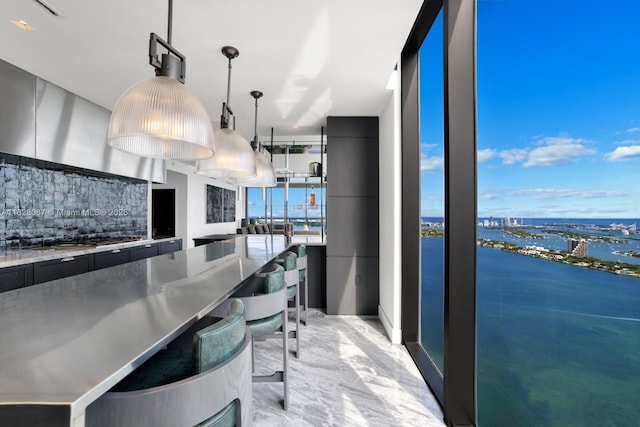 788 NE 23rd St Unit 5401, Miami, FL 33137 - kitchen featuring stainless steel countertops, dark cabinets, modern cabinets, backsplash, and a water view