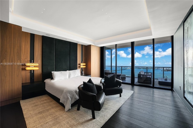 788 NE 23rd St Unit 5401, Miami, FL 33137 - bedroom with a wall of windows, access to outside, a water view, wood-type flooring, and a raised ceiling