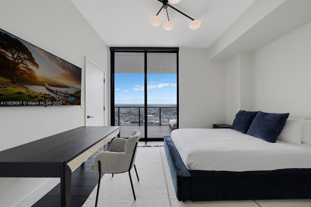 788 NE 23rd St Unit 5401, Miami, FL 33137 - bedroom featuring expansive windows, access to outside, a chandelier, and wood finished floors