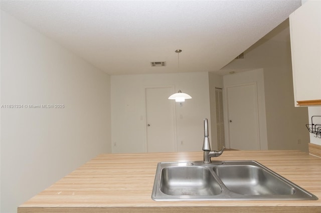 18328 NW 68th Ave Unit P, Hialeah, FL 33015 - kitchen featuring hanging light fixtures and wood counters