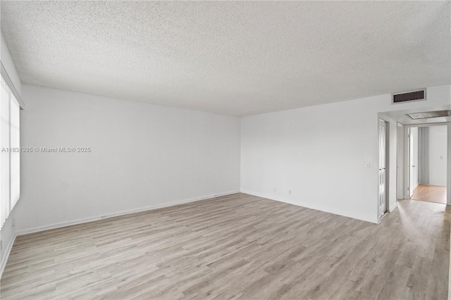 300 SW 134th Way Unit 413E, Pembroke Pines, FL 33027 - spare room featuring light wood-type flooring and a textured ceiling