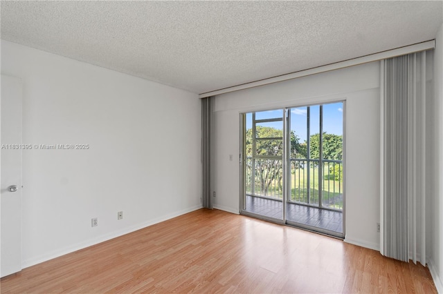 300 SW 134th Way Unit 413E, Pembroke Pines, FL 33027 - empty room featuring light wood-style flooring and a textured ceiling