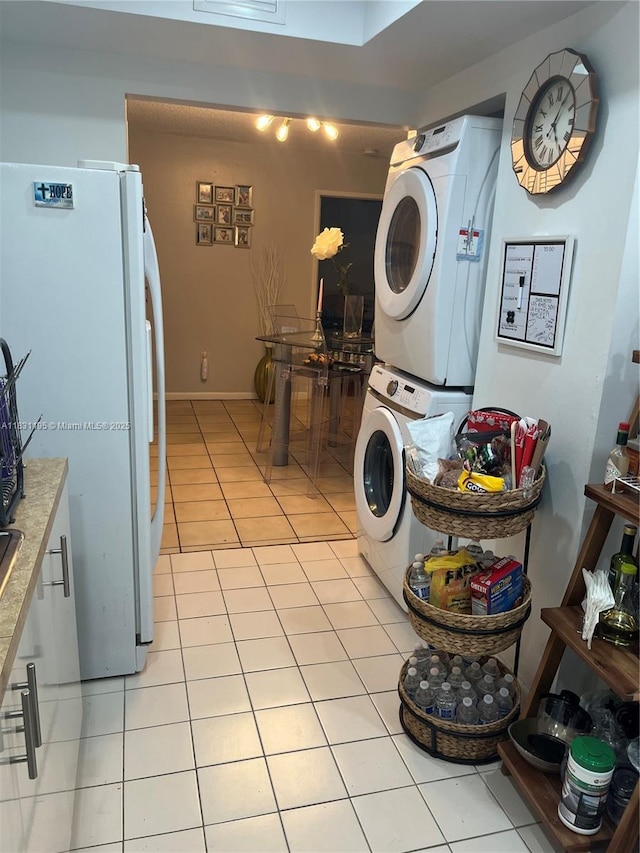 8251 NW 8th St Unit 214, Miami, FL 33126 - washroom featuring stacked washing machine and dryer and light tile patterned floors