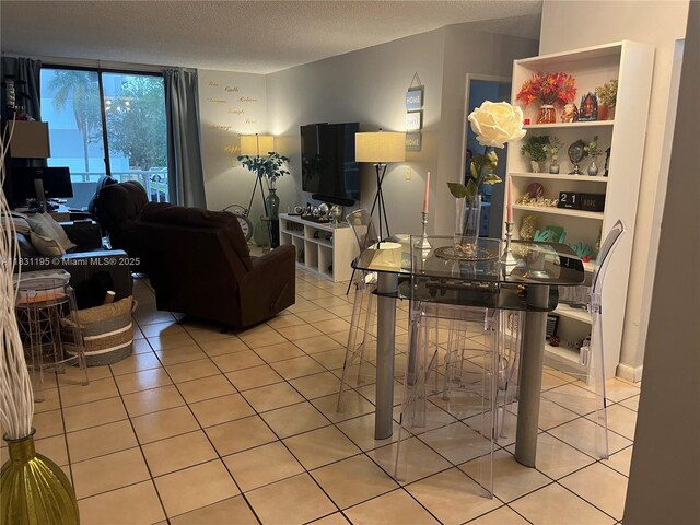 8251 NW 8th St Unit 214, Miami, FL 33126 - living area with light tile patterned floors and a textured ceiling