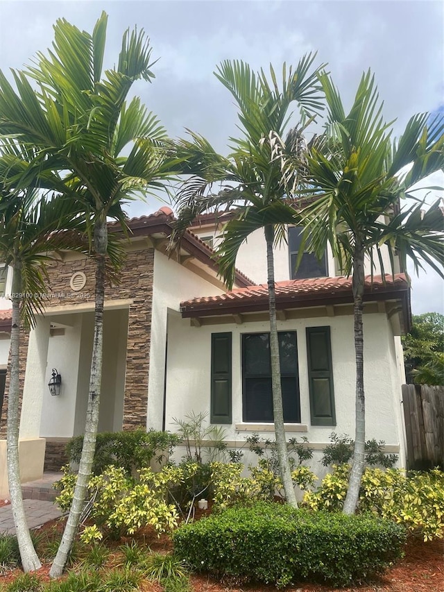 738 SE 37th Pl, Homestead, FL 33033 - view of side of property with stucco siding, stone siding, and a tile roof