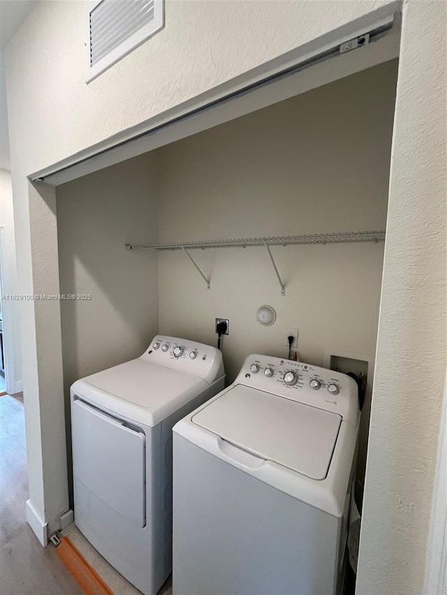 738 SE 37th Pl, Homestead, FL 33033 - washroom with washing machine and clothes dryer and wood finished floors