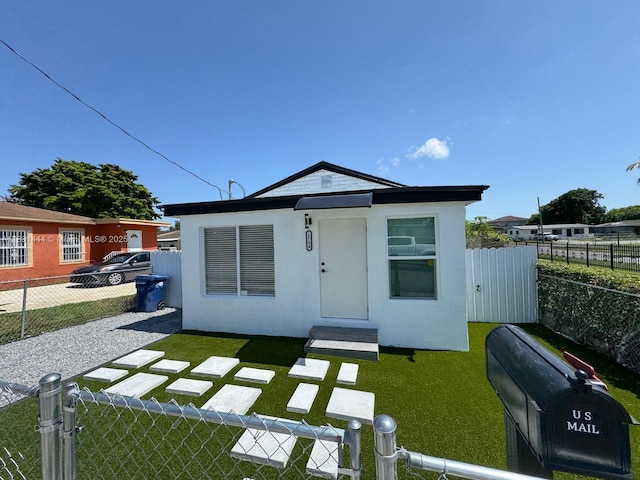 1794 NW 74th Ter, Miami, FL 33147 - view of front facade featuring a fenced backyard and stucco siding