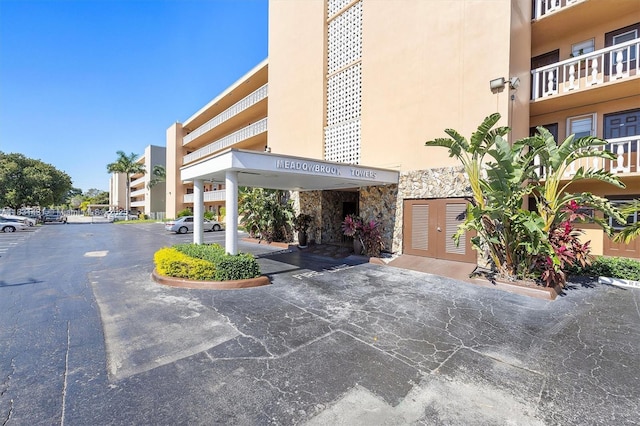 219 NE 14th Ave Unit 101, Hallandale Beach, FL 33009 - view of building exterior featuring uncovered parking
