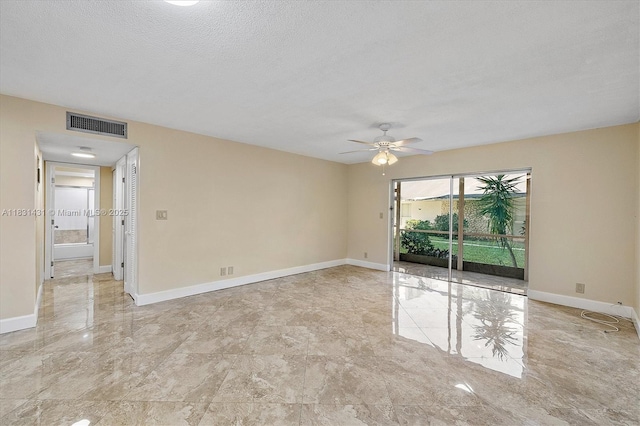 219 NE 14th Ave Unit 101, Hallandale Beach, FL 33009 - unfurnished room featuring ceiling fan, a textured ceiling, and marble finish flooring