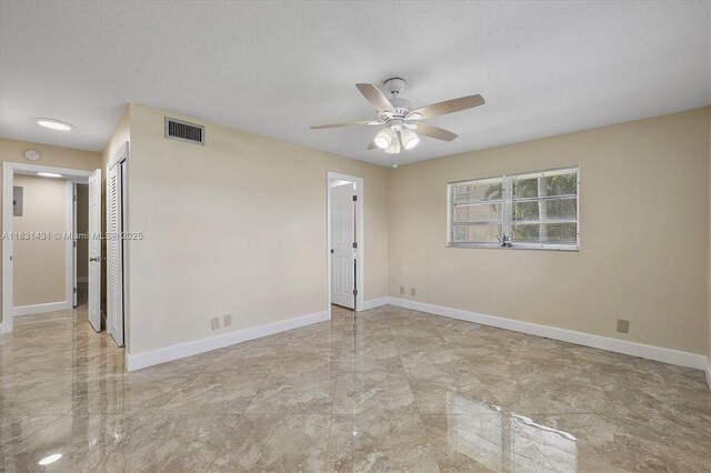 219 NE 14th Ave Unit 101, Hallandale Beach, FL 33009 - spare room with a ceiling fan, marble finish flooring, a textured ceiling, and a smoke detector