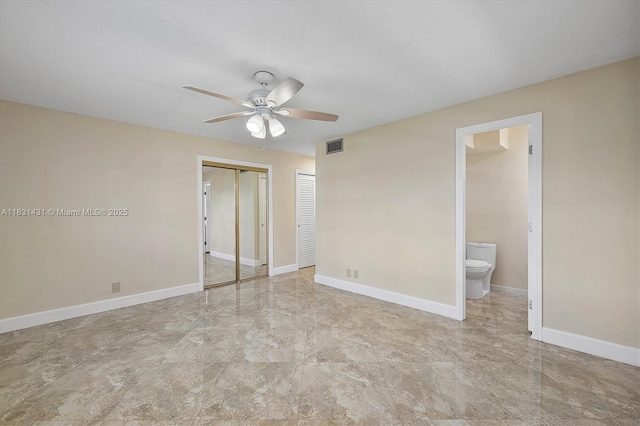 219 NE 14th Ave Unit 101, Hallandale Beach, FL 33009 - unfurnished bedroom featuring connected bathroom, multiple closets, and ceiling fan