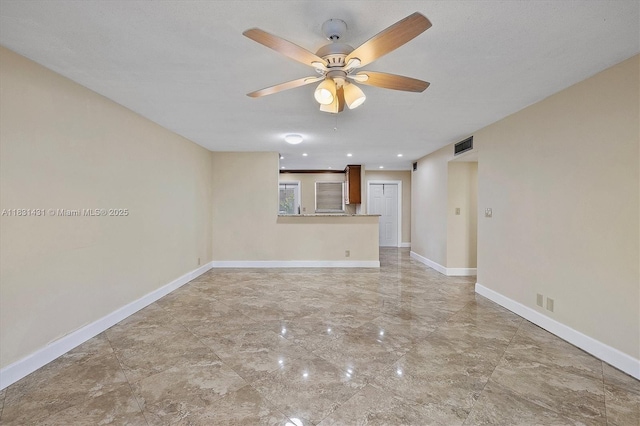 219 NE 14th Ave Unit 101, Hallandale Beach, FL 33009 - unfurnished living room featuring light marble finish floors and ceiling fan