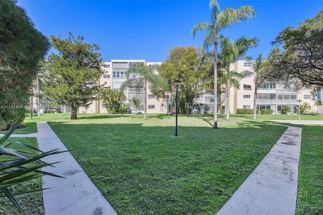 219 NE 14th Ave Unit 101, Hallandale Beach, FL 33009 - view of home's community with a lawn