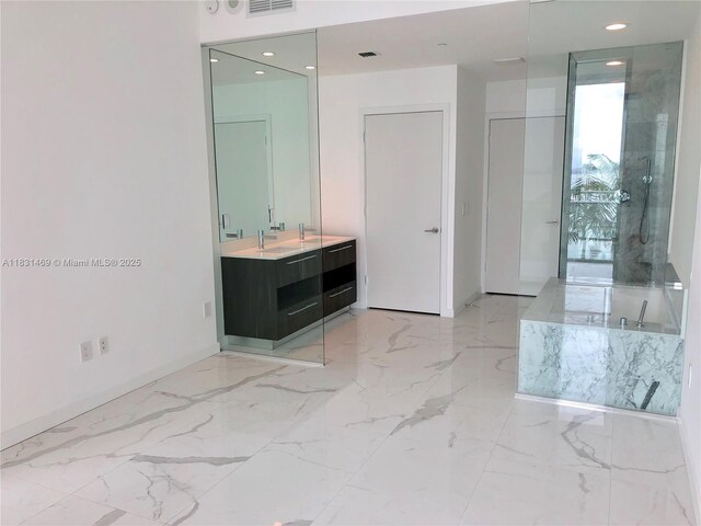 480 NE 31st St Unit 705, Miami, FL 33137 - full bathroom featuring marble tiled flooring, vanity, a garden tub, and recessed lighting