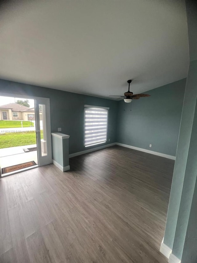 1305 SW 22, Cape Coral, FL 33991 - unfurnished living room with plenty of natural light, wood finished floors, and a ceiling fan