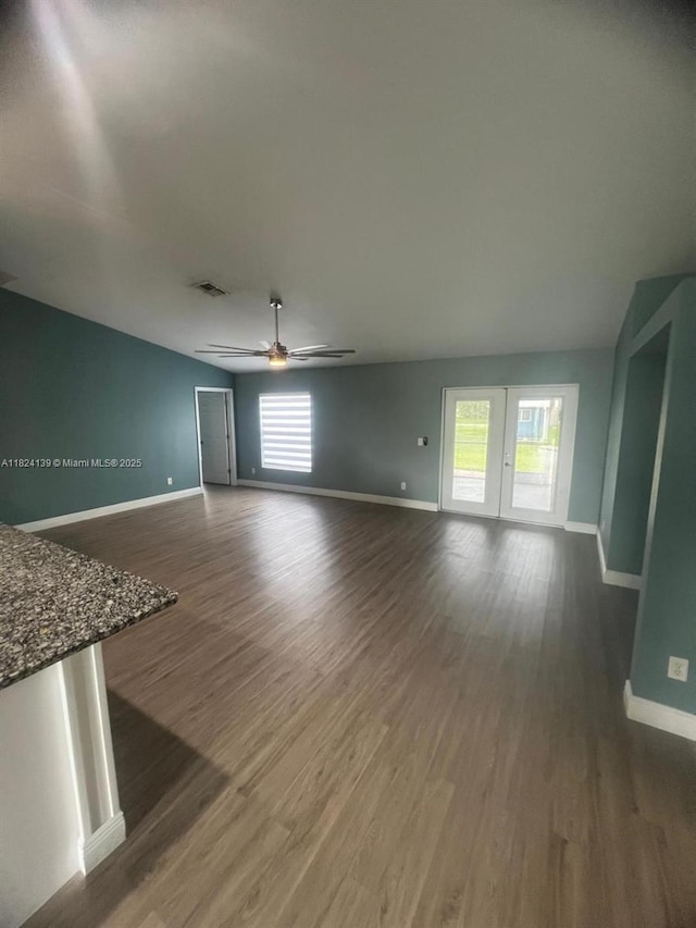 1305 SW 22, Cape Coral, FL 33991 - unfurnished living room featuring dark wood-style flooring and ceiling fan