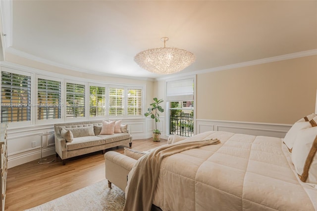 618 Valencia Ave Unit 101, Coral Gables, FL 33134 - bedroom with ornamental molding, a decorative wall, wood finished floors, a chandelier, and wainscoting