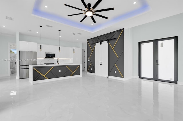 3209 45th St SW, Lehigh Acres, FL 33976 - unfurnished living room with a tray ceiling, a ceiling fan, recessed lighting, light marble finish floors, and french doors