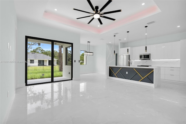 3209 45th St SW, Lehigh Acres, FL 33976 - unfurnished living room featuring a tray ceiling, recessed lighting, light marble finish floors, and ceiling fan
