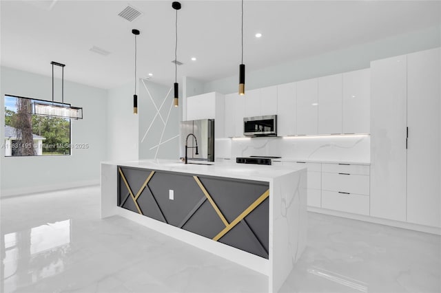 3209 45th St SW, Lehigh Acres, FL 33976 - kitchen featuring appliances with stainless steel finishes, modern cabinets, light marble finish flooring, white cabinetry, and recessed lighting