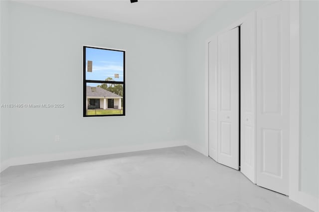 3209 45th St SW, Lehigh Acres, FL 33976 - unfurnished bedroom with a closet and baseboards