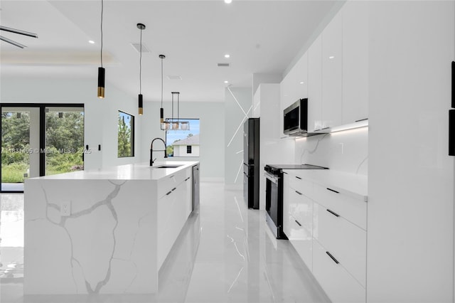 3209 45th St SW, Lehigh Acres, FL 33976 - kitchen with modern cabinets, appliances with stainless steel finishes, white cabinetry, a large island, and recessed lighting