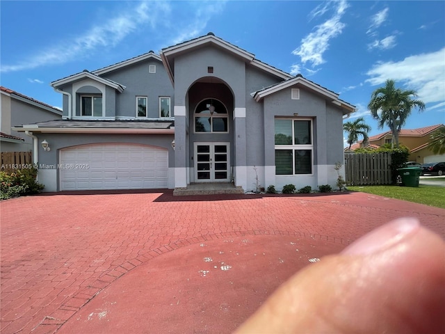11123 SW 156th Ct, Miami, FL 33196 - mediterranean / spanish-style house featuring stucco siding, decorative driveway, and a garage