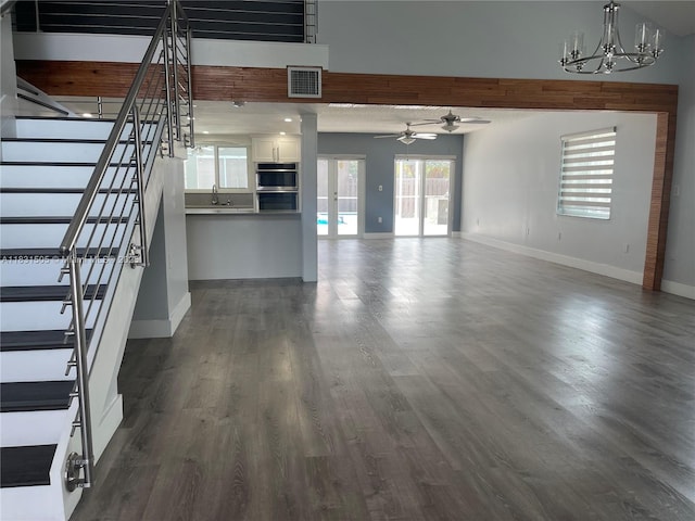 11123 SW 156th Ct, Miami, FL 33196 - unfurnished living room featuring a ceiling fan, a chandelier, stairway, and dark wood-style flooring