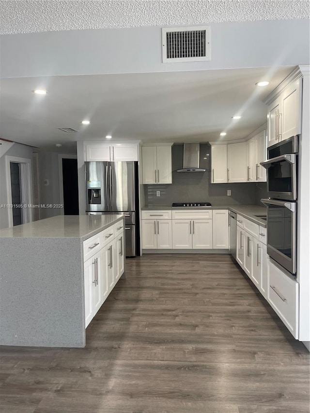 11123 SW 156th Ct, Miami, FL 33196 - kitchen featuring wall chimney exhaust hood, appliances with stainless steel finishes, dark wood-type flooring, recessed lighting, and white cabinets