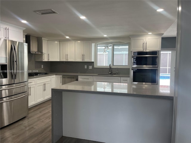 11123 SW 156th Ct, Miami, FL 33196 - kitchen featuring appliances with stainless steel finishes, wall chimney exhaust hood, white cabinetry, stone counters, and recessed lighting
