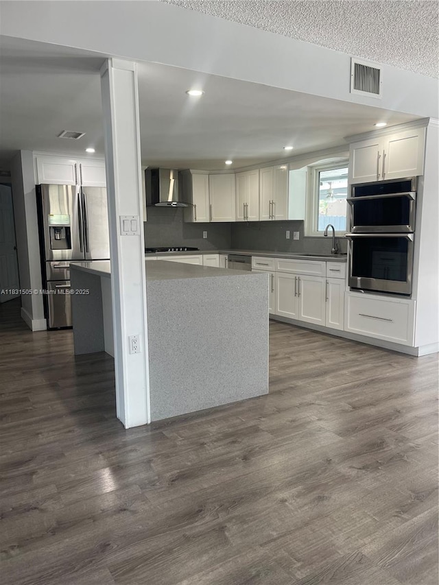 11123 SW 156th Ct, Miami, FL 33196 - kitchen featuring appliances with stainless steel finishes, wall chimney exhaust hood, white cabinetry, dark wood-type flooring, and recessed lighting