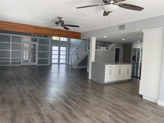 11123 SW 156th Ct, Miami, FL 33196 - unfurnished living room featuring a ceiling fan, dark wood-style flooring, a textured ceiling, french doors, and stairway